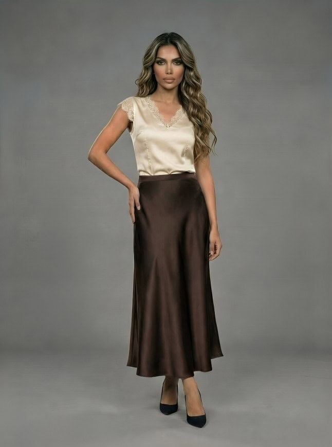Full body view of woman wearing fluid satin midi skirt